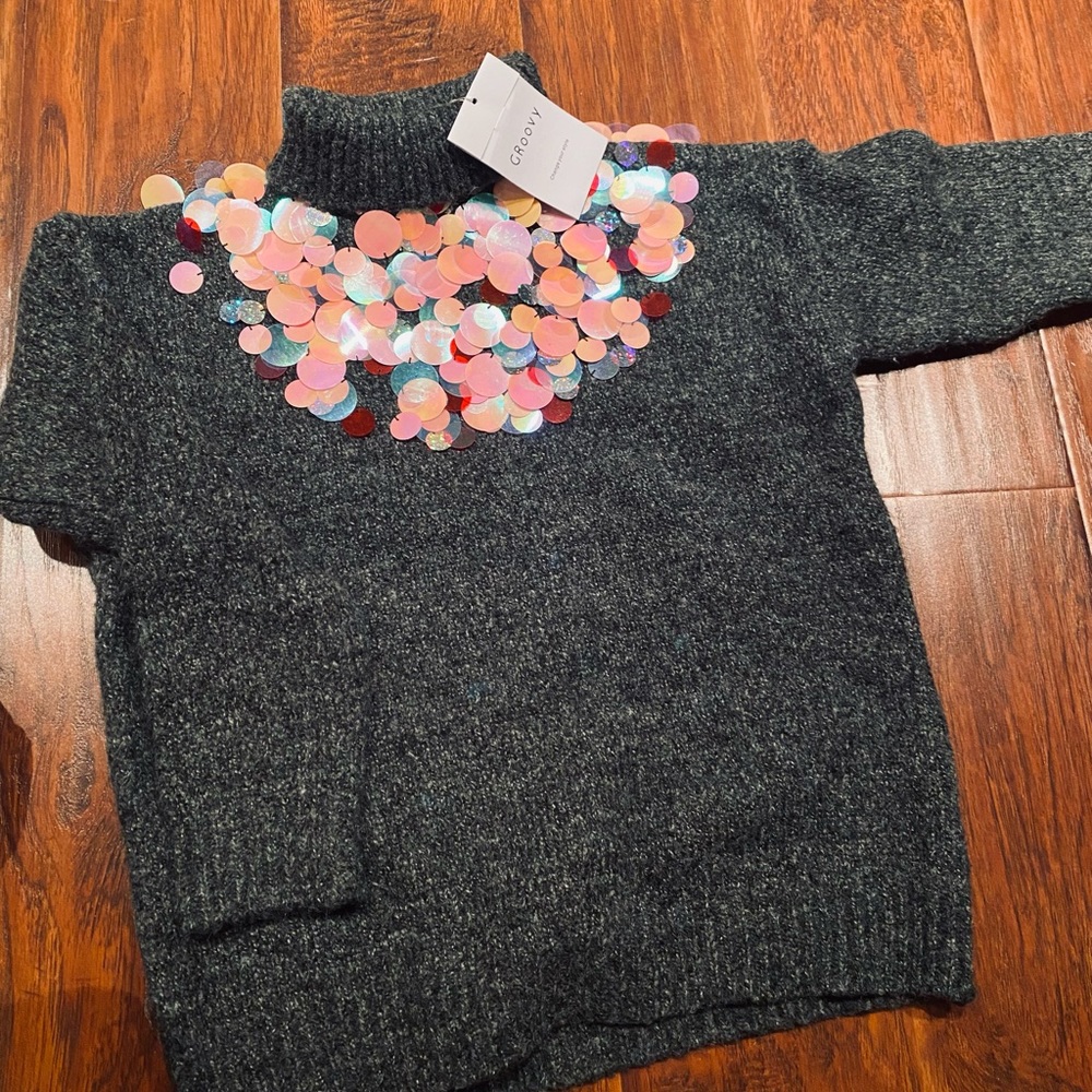 Brand new sweater fits around medium